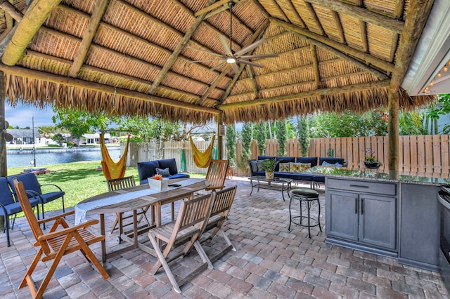 view of patio featuring an outdoor hangout area, a gazebo, a water view, and a fenced backyard
