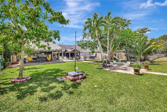 view of yard with a patio, a playground, and fence