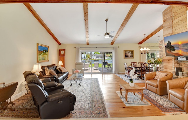 living area with baseboards, vaulted ceiling with beams, light wood finished floors, and ceiling fan with notable chandelier