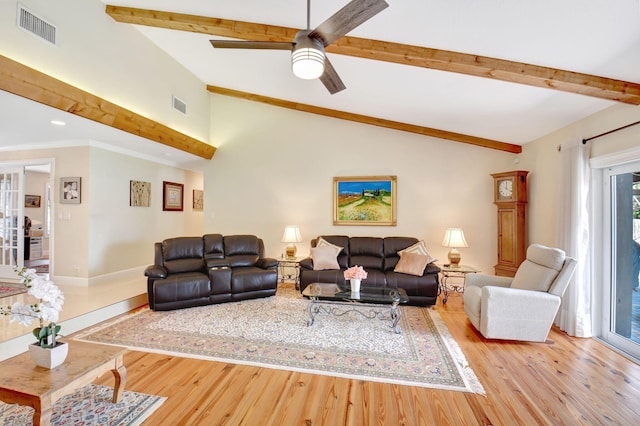 living area featuring visible vents, wood finished floors, and vaulted ceiling with beams