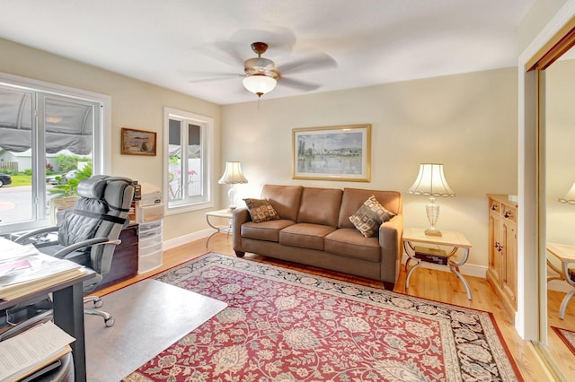 office area featuring ceiling fan, baseboards, and light wood-type flooring