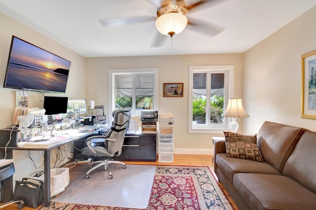 office with baseboards, ceiling fan, and wood finished floors