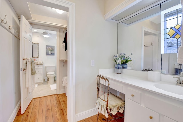 147 Oregon Ln, Boca Raton, FL 33487 - bathroom with hardwood / wood-style floors, vanity, ceiling fan, toilet, and baseboards