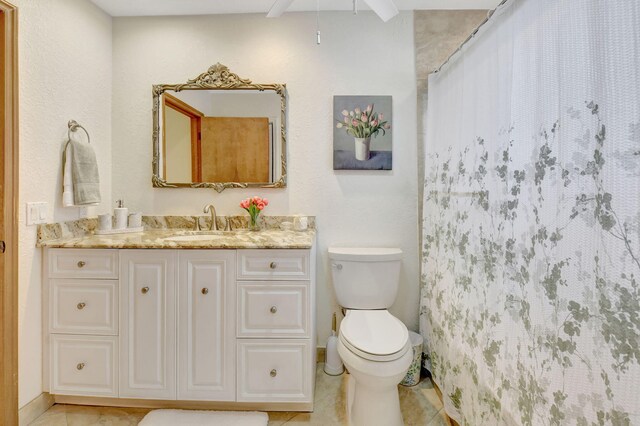 147 Oregon Ln, Boca Raton, FL 33487 - bathroom with toilet, vanity, tile patterned flooring, and ceiling fan