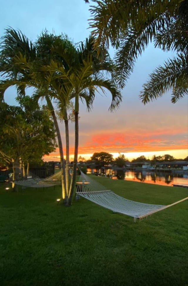 147 Oregon Ln, Boca Raton, FL 33487 - yard at dusk with a water view and a yard