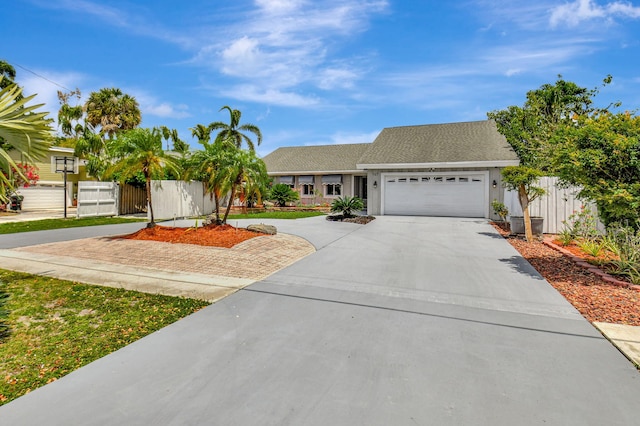 147 Oregon Ln, Boca Raton, FL 33487 - view of front of home featuring driveway, a garage, and fence