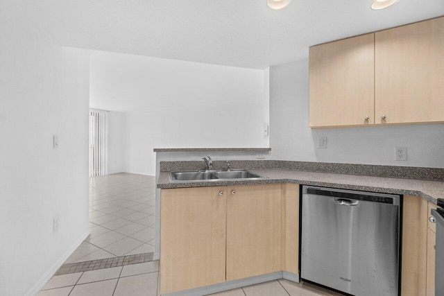 1801 N Flagler Dr Unit 828, West Palm Beach, FL 33407 - kitchen with stainless steel dishwasher, light brown cabinets, a sink, and light tile patterned floors
