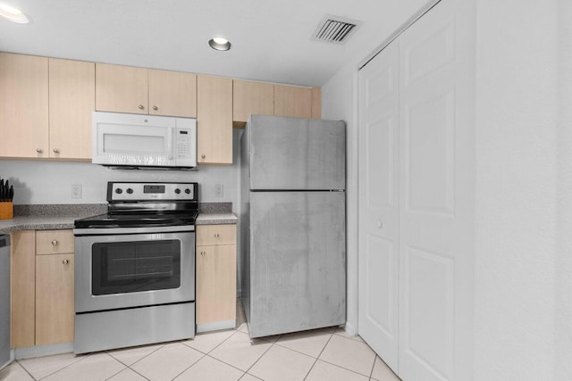 1801 N Flagler Dr Unit 828, West Palm Beach, FL 33407 - kitchen with appliances with stainless steel finishes, light brown cabinetry, light tile patterned floors, and recessed lighting