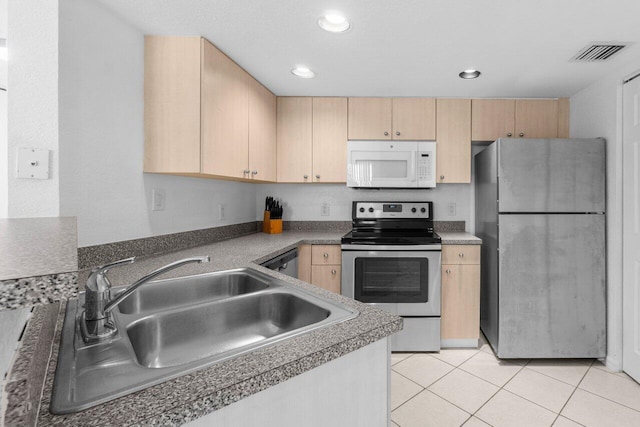 1801 N Flagler Dr Unit 828, West Palm Beach, FL 33407 - kitchen with stainless steel appliances, light brown cabinets, a sink, light tile patterned floors, and recessed lighting