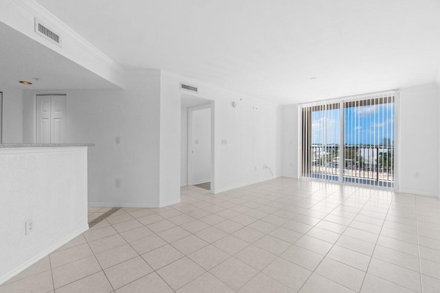 1801 N Flagler Dr Unit 828, West Palm Beach, FL 33407 - unfurnished room with light tile patterned floors, floor to ceiling windows, and baseboards