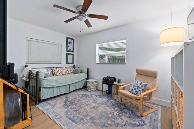 bedroom featuring baseboards, ceiling fan, and wood finished floors