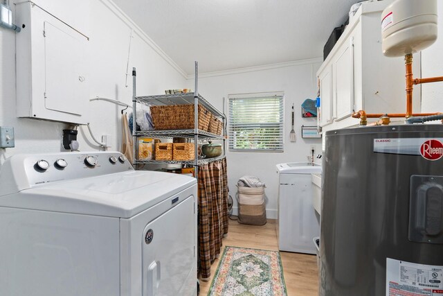 clothes washing area with crown molding, cabinet space, light wood-style flooring, independent washer and dryer, and water heater