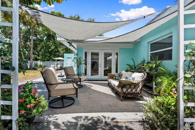 view of patio with french doors, fence, and outdoor lounge area