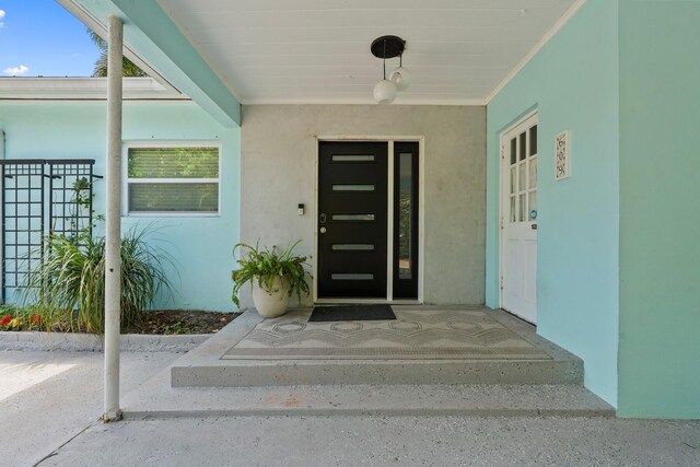 entrance to property featuring stucco siding