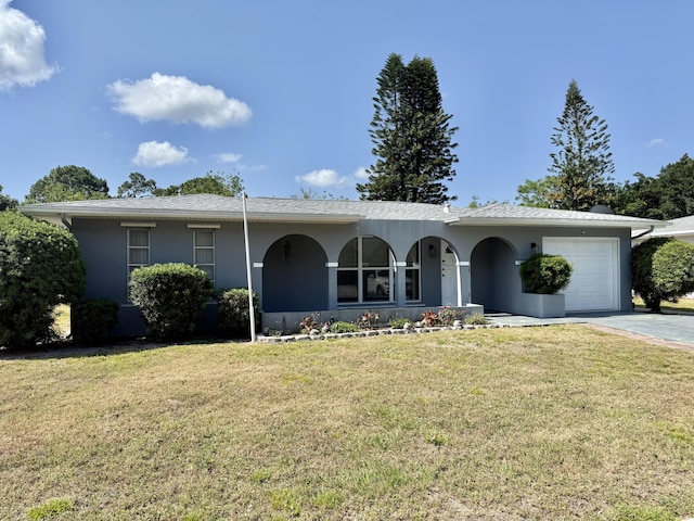single story home featuring a front lawn, driveway, stucco siding, and a garage