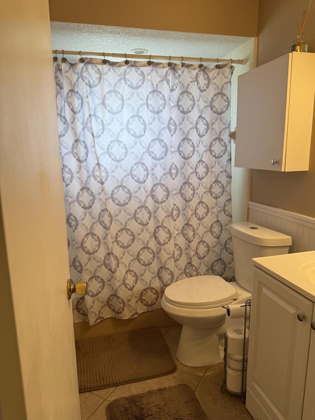 bathroom with tile patterned flooring, toilet, and vanity
