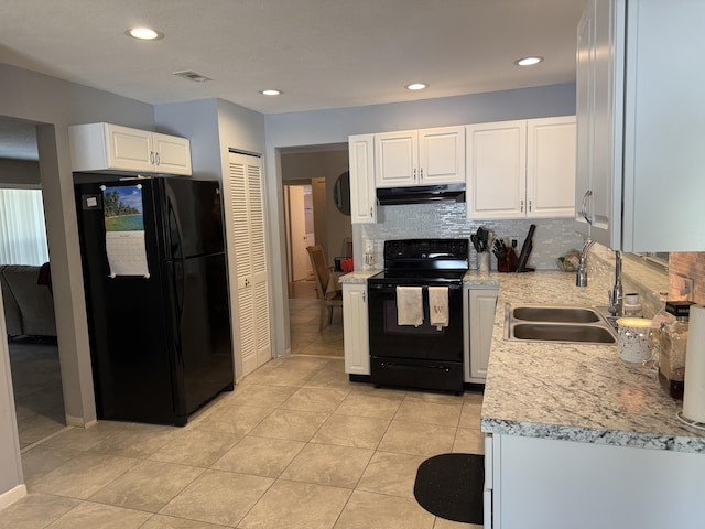 kitchen with a sink, black appliances, visible vents, under cabinet range hood, and white cabinets