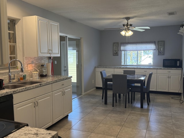 kitchen with a ceiling fan, a sink, visible vents, black appliances, and backsplash
