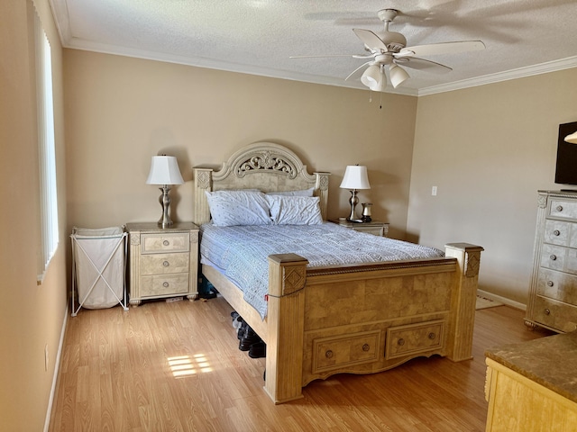 bedroom with ornamental molding, a textured ceiling, a ceiling fan, baseboards, and light wood-style floors