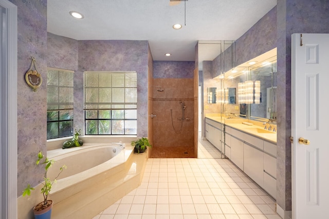 bathroom with double vanity, tile patterned floors, recessed lighting, tiled shower, and a bath