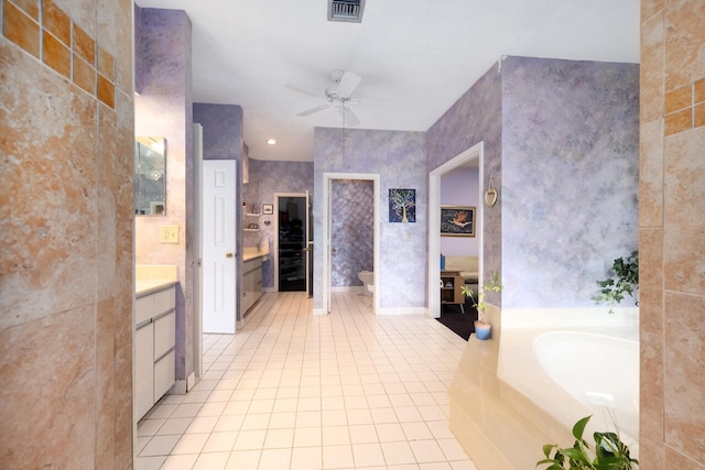 bathroom with a ceiling fan, a bath, visible vents, tile patterned flooring, and vanity