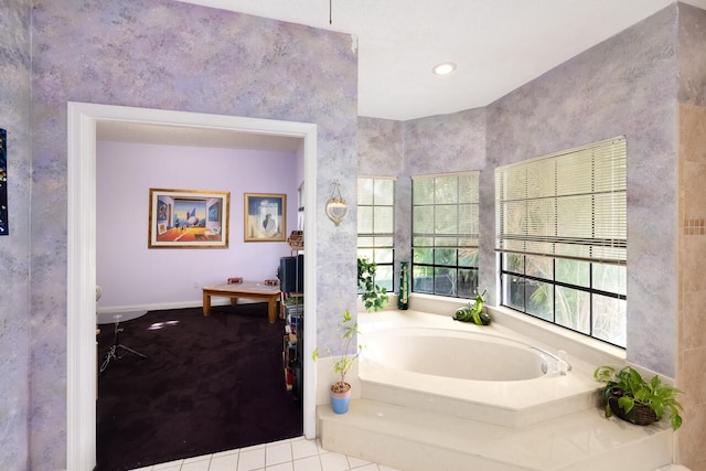 bathroom with tile patterned floors and a garden tub