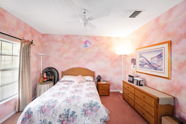 carpeted bedroom featuring visible vents, a ceiling fan, and baseboards