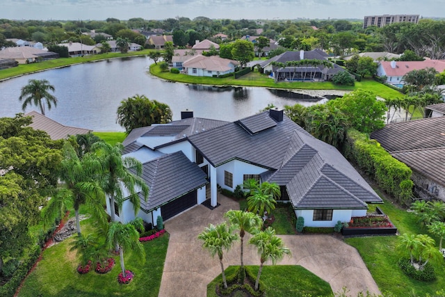 birds eye view of property with a water view and a residential view