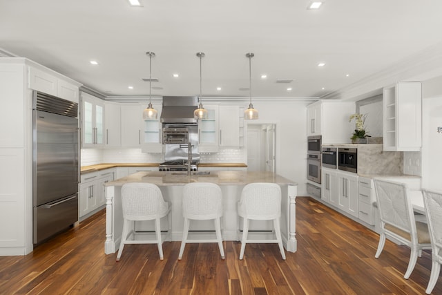103 River Dr, Tequesta, FL 33469 - kitchen featuring open shelves, stainless steel built in fridge, decorative backsplash, white cabinetry, and ornamental molding