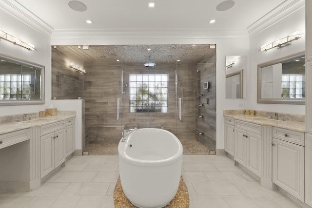 103 River Dr, Tequesta, FL 33469 - full bathroom featuring a stall shower, two vanities, a soaking tub, ornamental molding, and tile patterned flooring