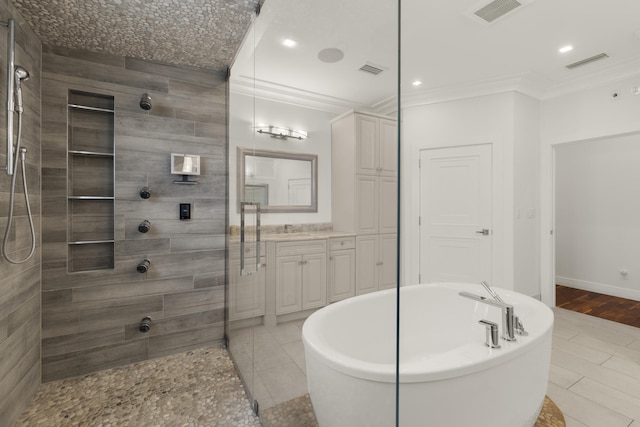 103 River Dr, Tequesta, FL 33469 - full bath featuring crown molding, vanity, a tile shower, a soaking tub, and baseboards