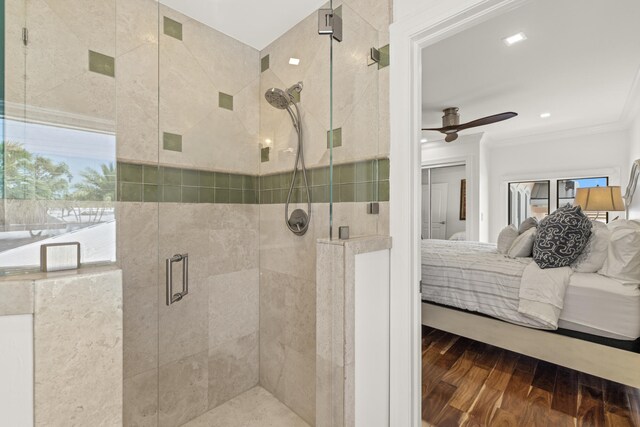 103 River Dr, Tequesta, FL 33469 - ensuite bathroom with ornamental molding, ceiling fan, wood finished floors, and a stall shower