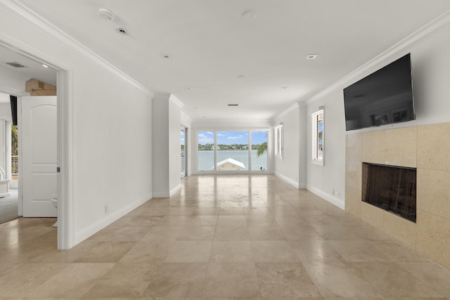 103 River Dr, Tequesta, FL 33469 - unfurnished living room with ornamental molding, a tiled fireplace, and baseboards