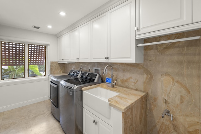 103 River Dr, Tequesta, FL 33469 - laundry room with independent washer and dryer, cabinet space, baseboards, and recessed lighting
