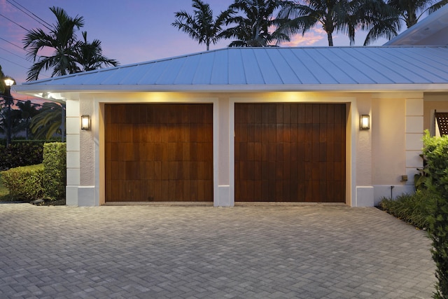 103 River Dr, Tequesta, FL 33469 - view of garage at dusk