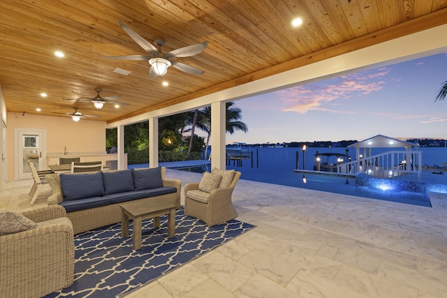 103 River Dr, Tequesta, FL 33469 - view of patio featuring an outdoor living space, a ceiling fan, and a dock