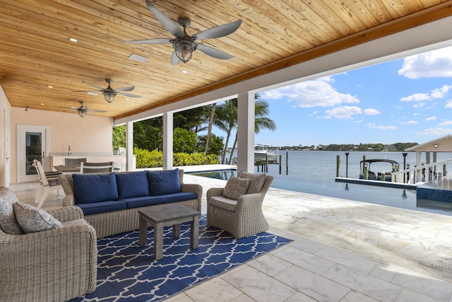 103 River Dr, Tequesta, FL 33469 - view of patio with an outdoor living space, ceiling fan, a water view, a dock, and boat lift