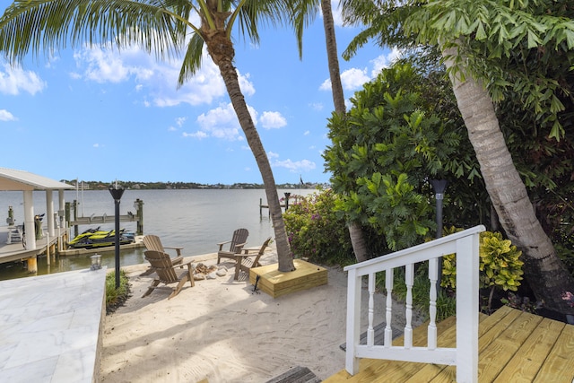 103 River Dr, Tequesta, FL 33469 - dock area with a water view, a patio, and a fire pit