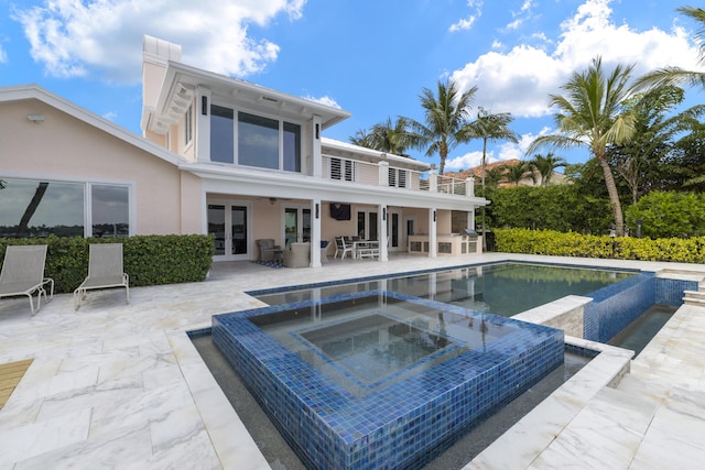 103 River Dr, Tequesta, FL 33469 - swimming pool with french doors, an in-ground hot tub, and a patio area