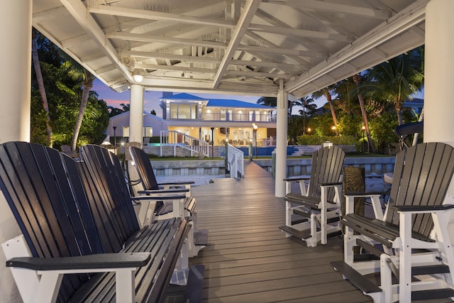 103 River Dr, Tequesta, FL 33469 - deck at dusk featuring a dock