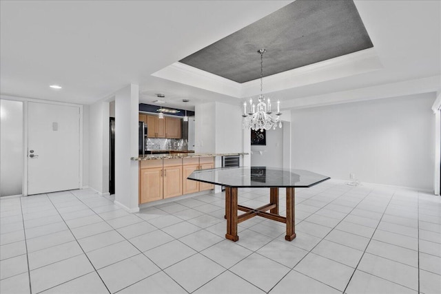 1640 Twelve Oaks Way Unit 205, North Palm Beach, FL 33408 - kitchen with an inviting chandelier, tasteful backsplash, a tray ceiling, and light tile patterned flooring