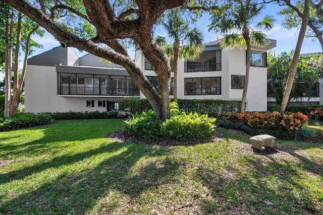 1640 Twelve Oaks Way Unit 205, North Palm Beach, FL 33408 - rear view of property with a yard and stucco siding
