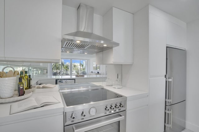 354 Chilean Ave Unit 4D, Palm Beach, FL 33480 - kitchen with stainless steel appliances, wall chimney exhaust hood, white cabinetry, modern cabinets, and light countertops