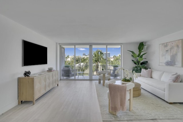 354 Chilean Ave Unit 4D, Palm Beach, FL 33480 - living area featuring floor to ceiling windows and light wood-style flooring