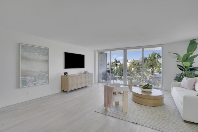 354 Chilean Ave Unit 4D, Palm Beach, FL 33480 - living area featuring a wall of windows and wood finished floors