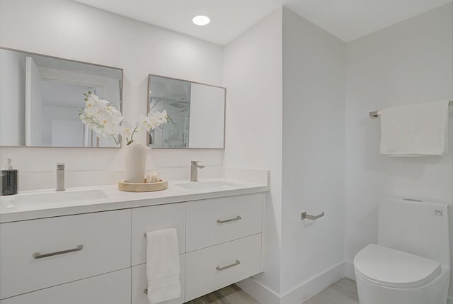 354 Chilean Ave Unit 4D, Palm Beach, FL 33480 - full bath featuring double vanity, toilet, baseboards, and wood finished floors