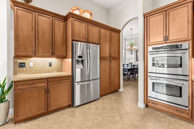8837 Woodgrove Ridge Ct, Boynton Beach, FL 33473 - dining space featuring crown molding, arched walkways, baseboards, and a high ceiling