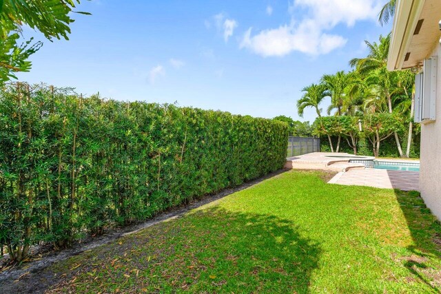 8837 Woodgrove Ridge Ct, Boynton Beach, FL 33473 - view of yard featuring a patio, fence, and a pool with connected hot tub