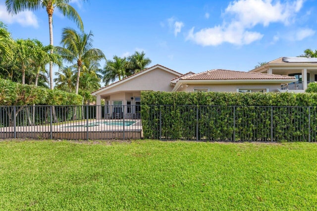 8837 Woodgrove Ridge Ct, Boynton Beach, FL 33473 - rear view of house featuring fence, a tile roof, stucco siding, a fenced in pool, and a lawn