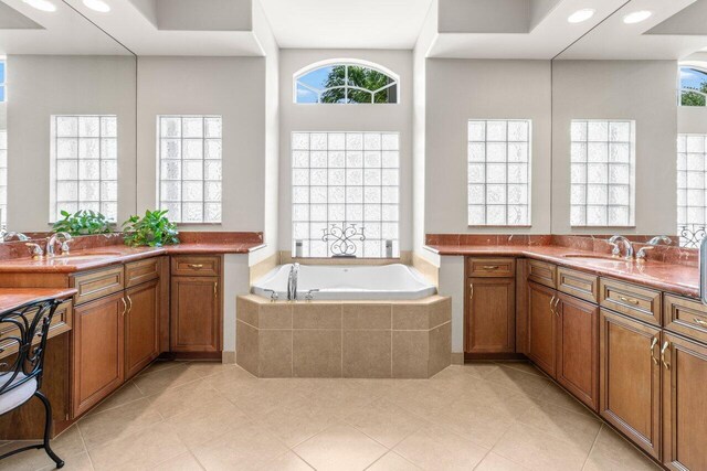 8837 Woodgrove Ridge Ct, Boynton Beach, FL 33473 - bathroom with tile patterned floors, two vanities, a sink, and a garden tub